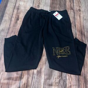 Nike woman’s Black Joggers with Gold Logo size L